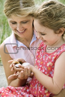 Mother and Daughter Looking at Shells