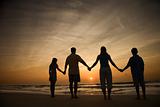 Family Holding Hands on Beach 