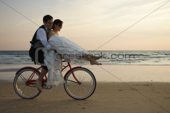 Couple Riding Bike on Beach