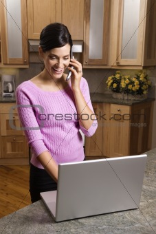 Woman on Cell Phone with Laptop