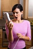 Woman Holding Phone in Disbelief