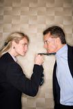 Angry Businesswoman Pulling Man's Tie