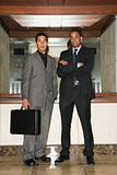 Two Businessmen Standing in Lobby
