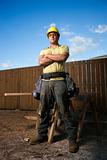 Male Construction Worker Stands with Folded Arms