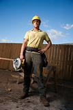 Construction Worker Standing with Saw