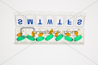 Pills in Open Pill Organizer. Isolated
