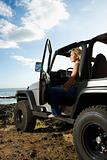 Woman Sitting in an SUV at the Beach
