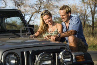 Couple With Map on Car Hood