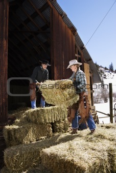 Attractive Couple Moving Hay Bales
