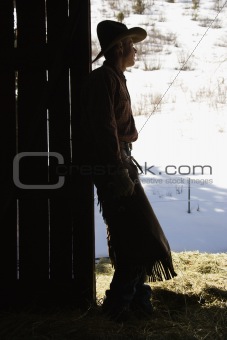 Cowboy Leaning in Doorway of Barn