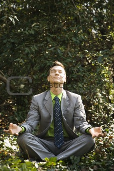 Businessman in Meditation Outside