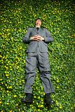 Young Businessman Lying in Flower Patch