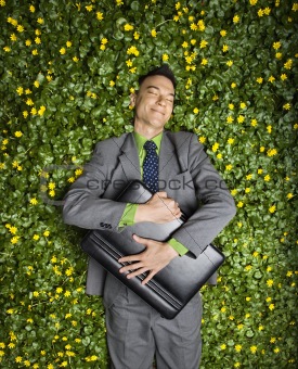 Businessman Lying in Flower Patch