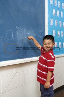 Boy in front of Blackboard