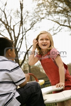 Young Girl and Boy Playing on Playground