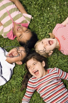 Children Lying in Clover Screaming With Heads Together