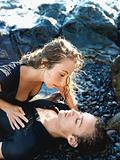 Attractive Young Couple Lying on Rocks