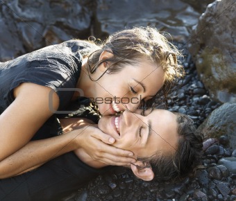 Attractive Young Couple on Rocks Smiling