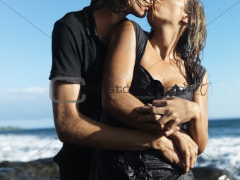 Attractive Young Couple Embracing and Kissing