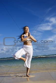 Woman Doing Yoga on Beach