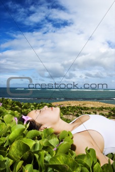 Woman Lying in Plants Near Beach