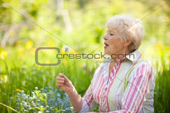 Senior woman with dandelion