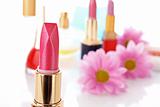 New lipstick on cosmetics and flower  background