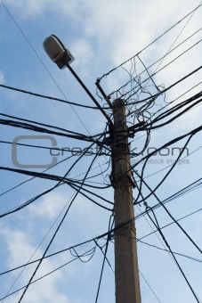 Lamp pole and cross of tangled electric wires
