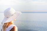 Girl in a white hat on the beach