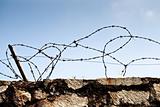 Stone wall with barbed wire