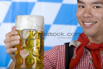 Smiling young man holding Oktoberfest beer stein (Mass)