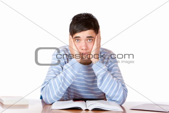 Young handsome sad male student learns with study books