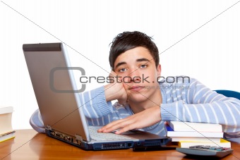 Young frustrated sad male teenage student learning on computer l