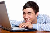 Young happy smiling male teenage student use computer laptop