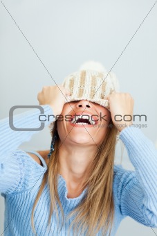 woman covering face with hat
