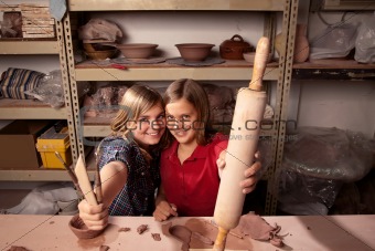 Cute young girls in clay studio
