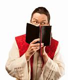 Pastor looking out from behind Bible
