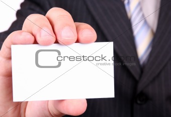 man is holding a business card