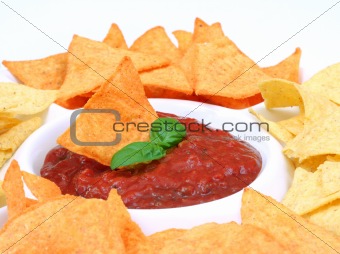 Nachos and salsa dip in a bowl