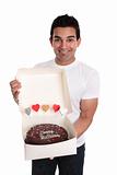 Adult man holding a chocolate birthday cake