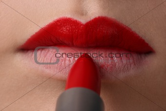 The woman draws lips