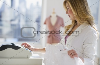store employee working behind register
