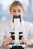 female scientist with microscope
