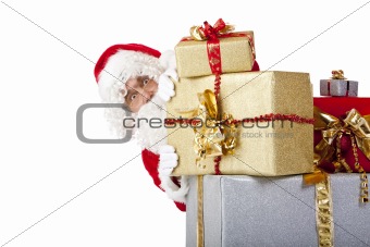 Santa Claus is hiding behind Christmas gift boxes