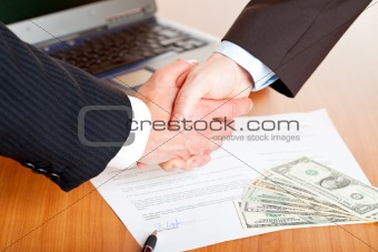 Handshake of businessmen after signing a contract