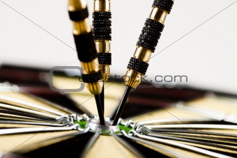 Dart on bulls eye target of dartboard