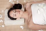 Attractive woman getting flower spa treatment