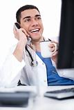 Smiling young doctor over phone