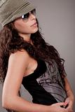 Side pose of a woman with sunglasses and cap