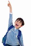 Young school boy excitingly shouts and raise his hand up